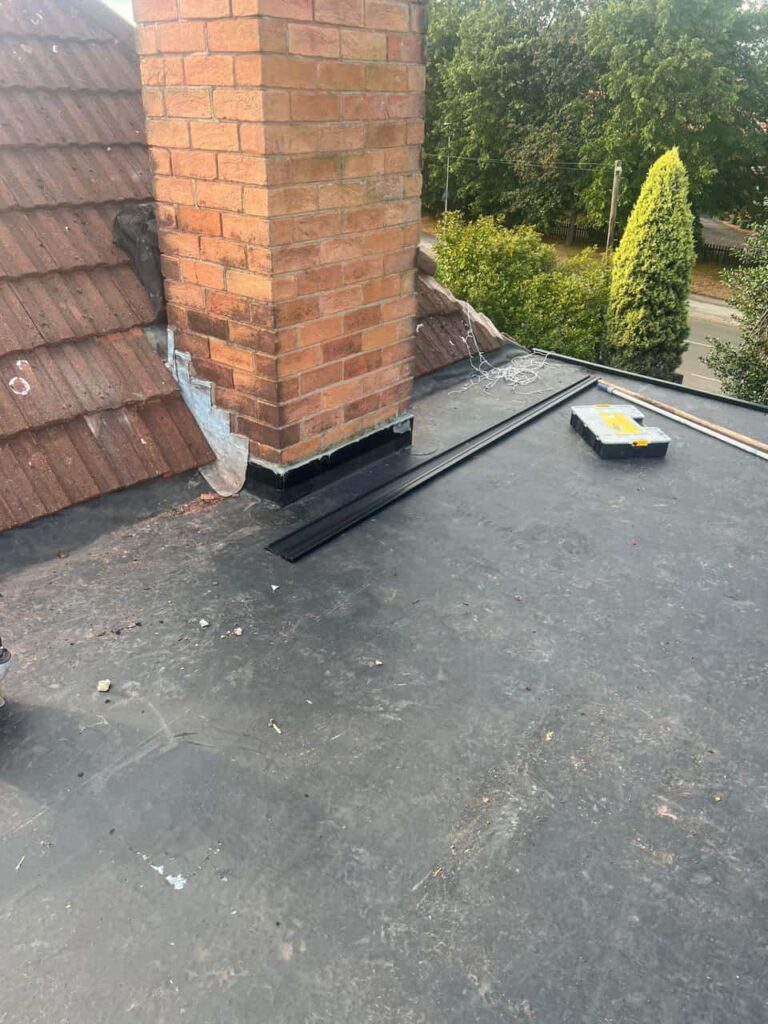 This is a photo of a flat roof which has just been repaired, there is also a chimney stack and some leadwork has also been dressed. Works carried out by Kirkby in Ashfield Roofing Repairs